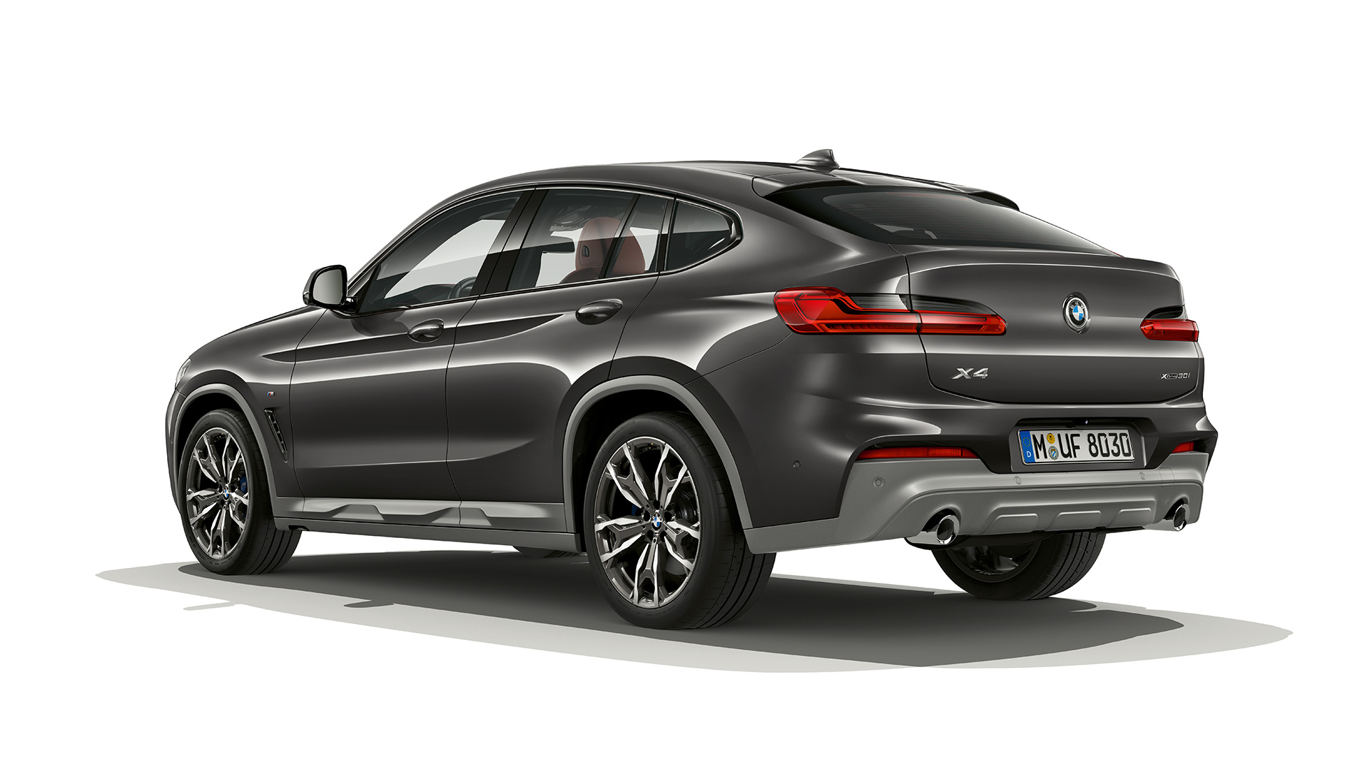 Vista trasera de tres cuartos del BMW X4 Modelo X M Sport Vista trasera de tres cuartos del BMW X4 xDrive30i Modelo M Sport X 2018 Sophisto Grey efecto brillante