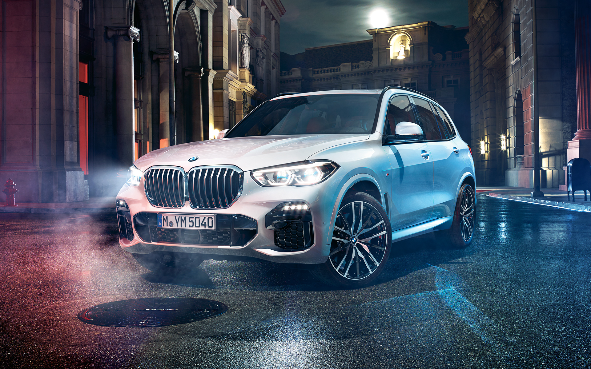 Front shot of the BMW X5 at night in an urban setting