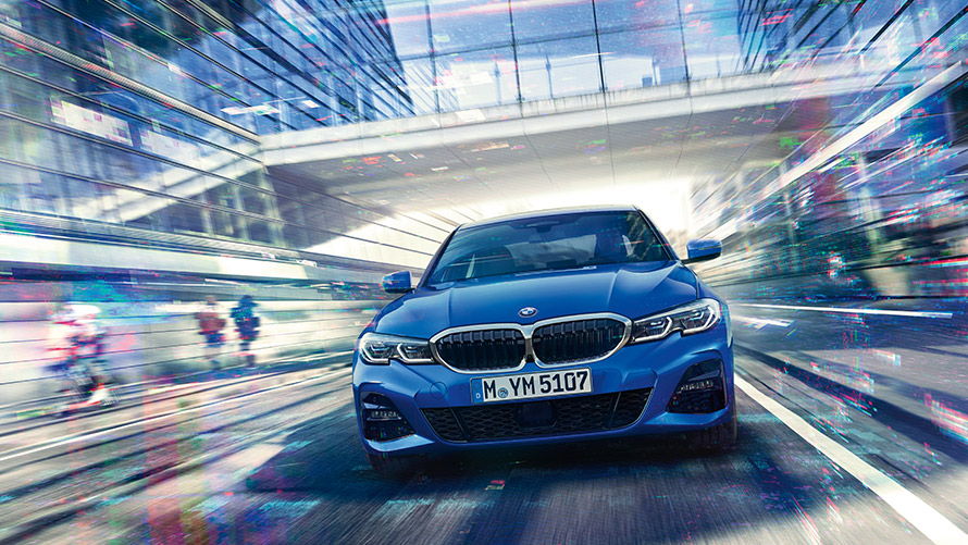 BMW Personal CoPilot: intelligent Driving Man is driving a BMW looking at the BMW Personal CoPilot driver assistance system.